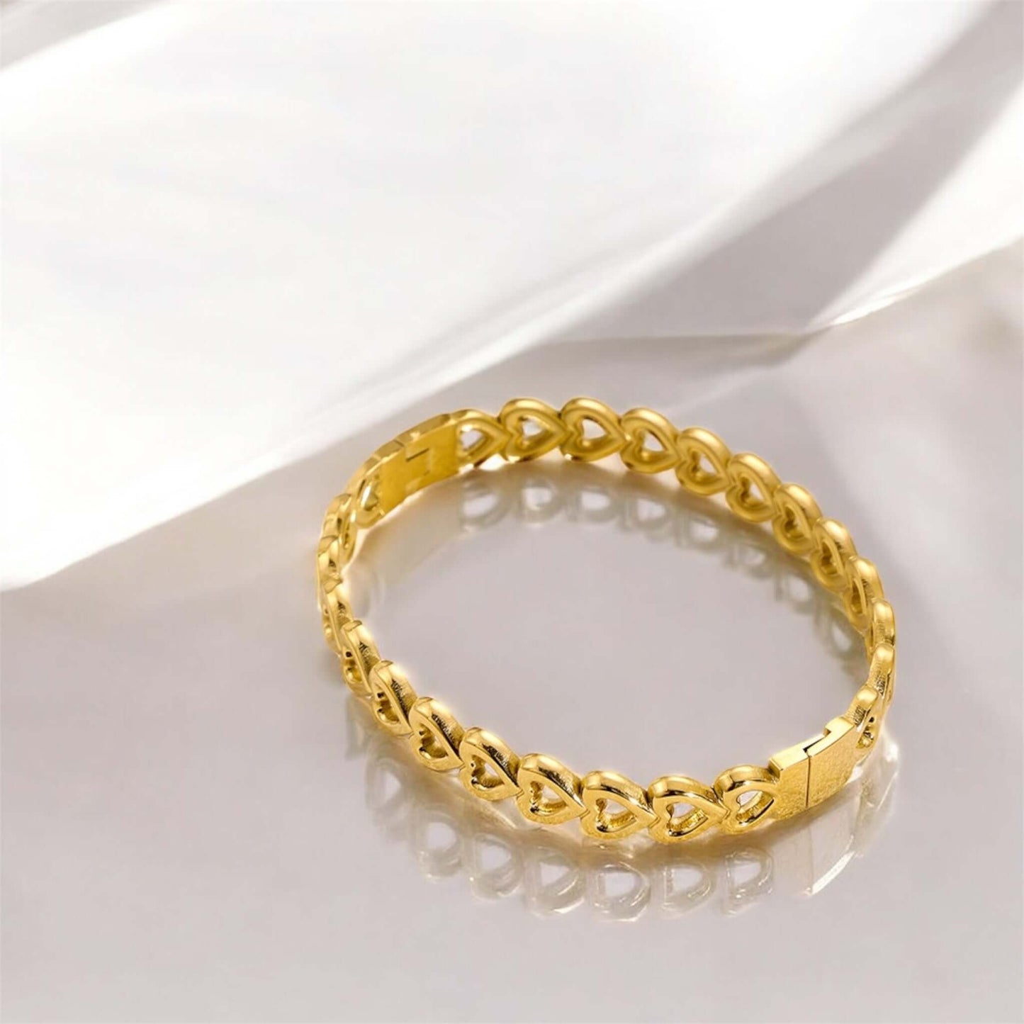 AMOR BRACELET with golden heart design, made of stainless steel, perfect for elegant outfits.
